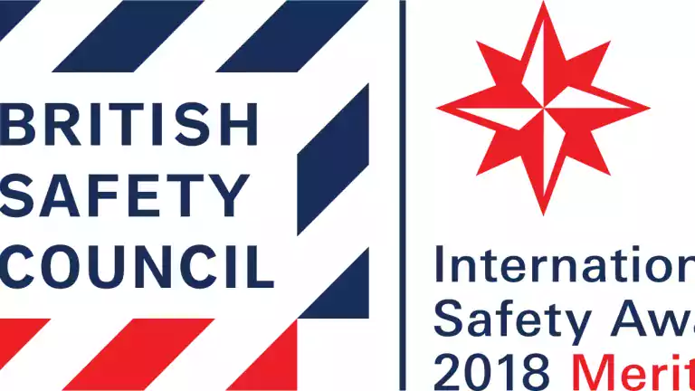 British Safety Council International Safety Awards 2018 Merit logo featuring a red and blue compass star and bold text on a white background.